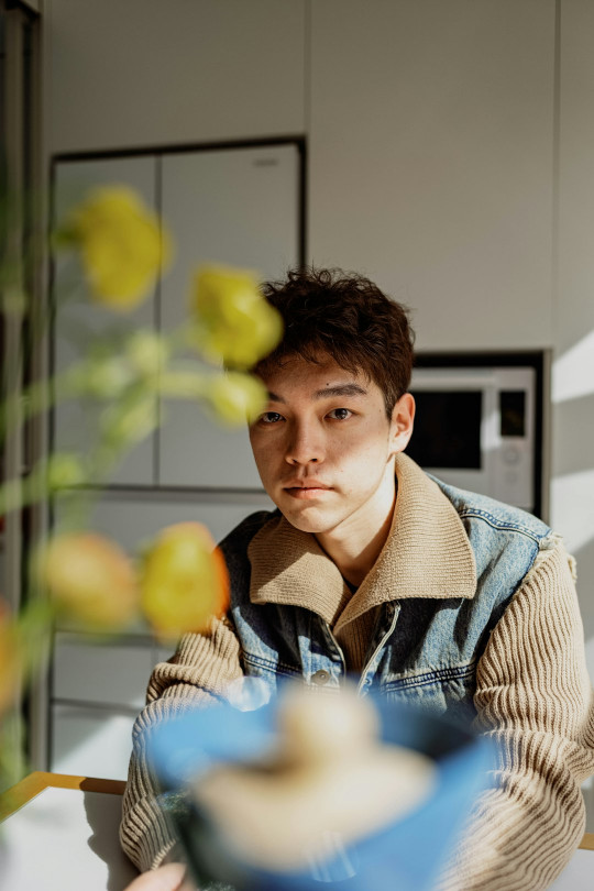 A man sitting at a table in a kitchen