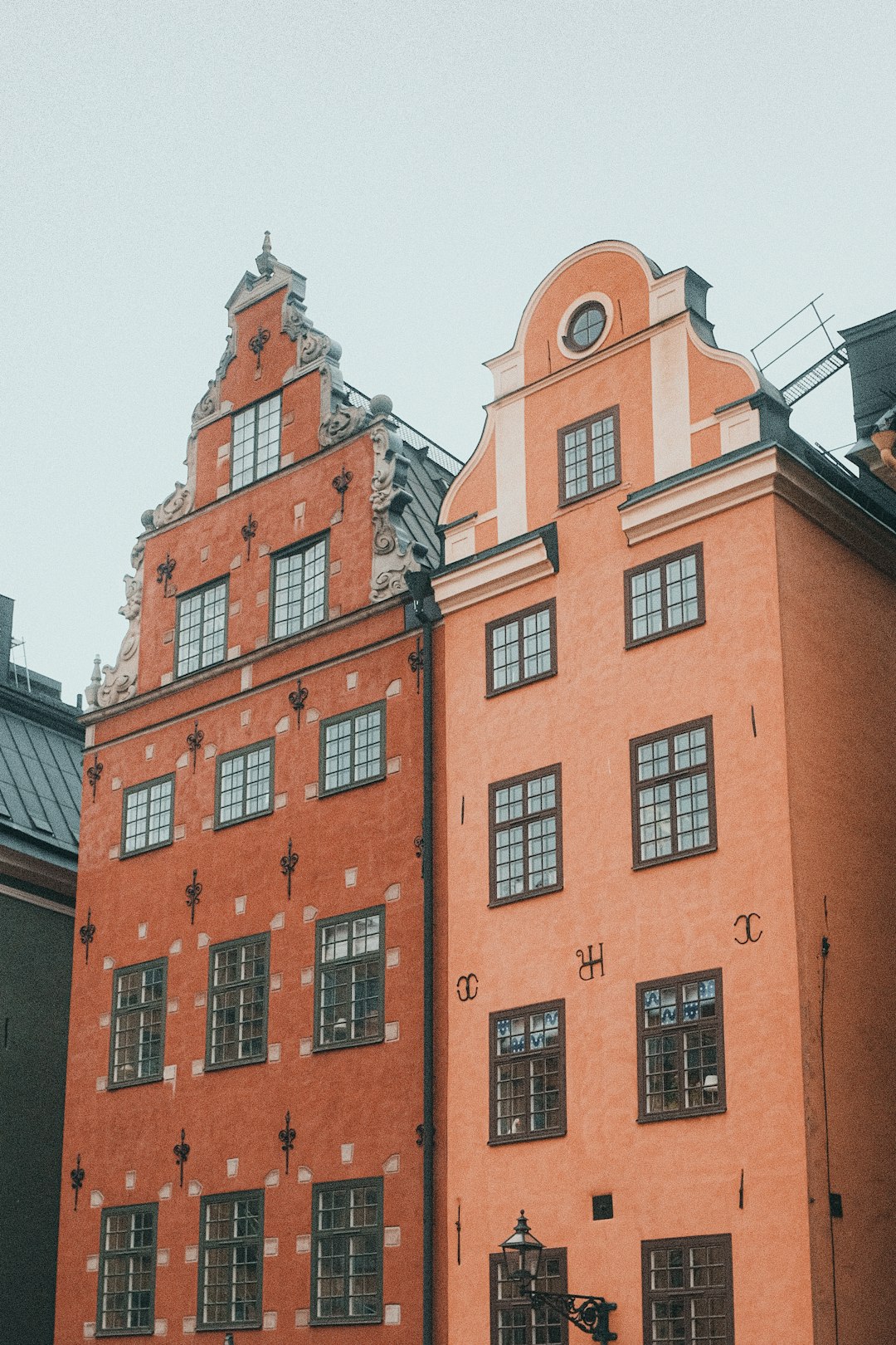 A tall red brick building with a clock on it's side