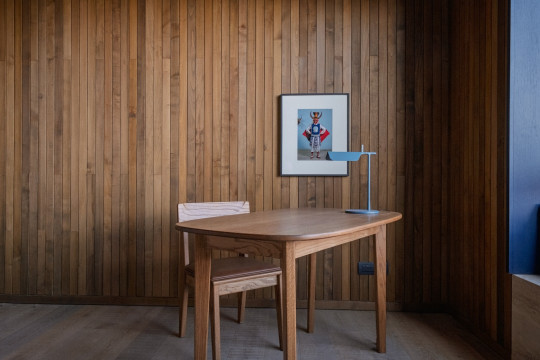 A room with wood paneling and a wooden table