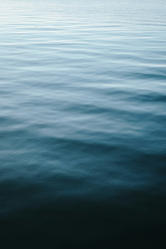 A large body of water with a boat in the distance