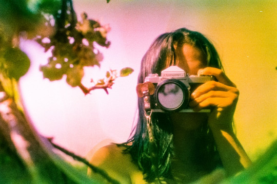 A woman taking a picture of herself with a camera