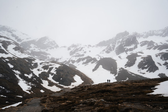 A man standing on top of a snow covered mountain