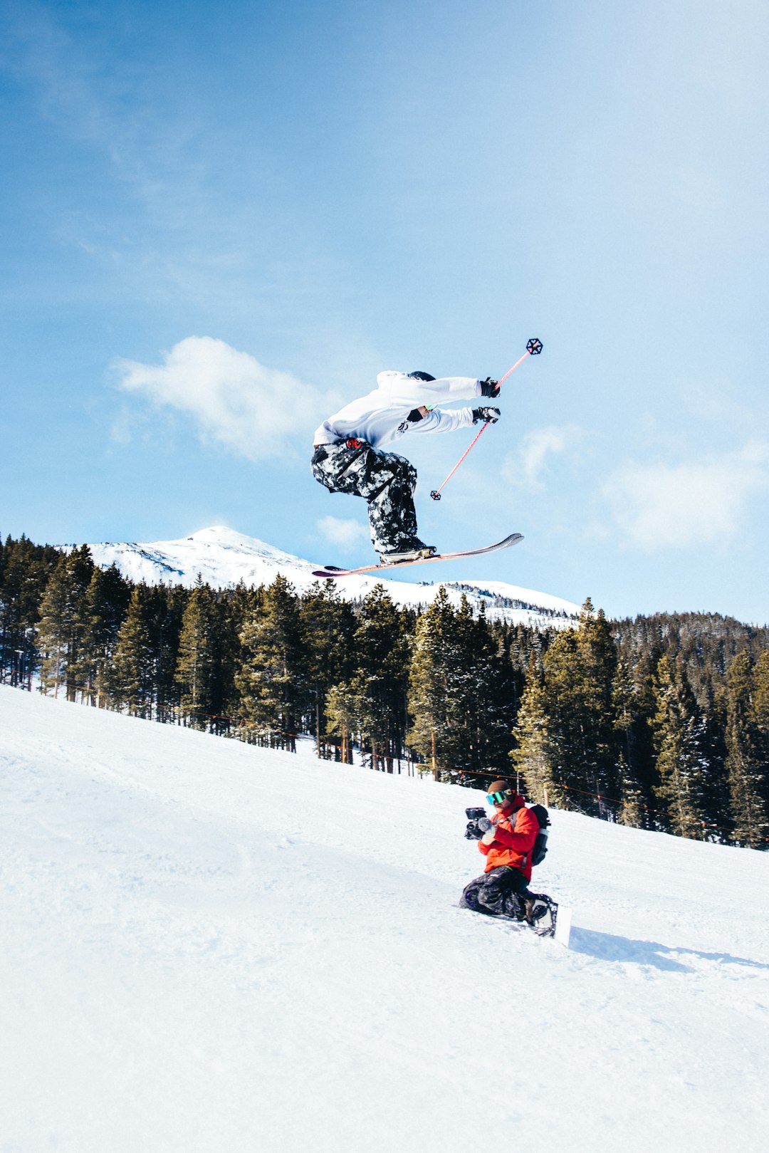 A man flying through the air while riding skis