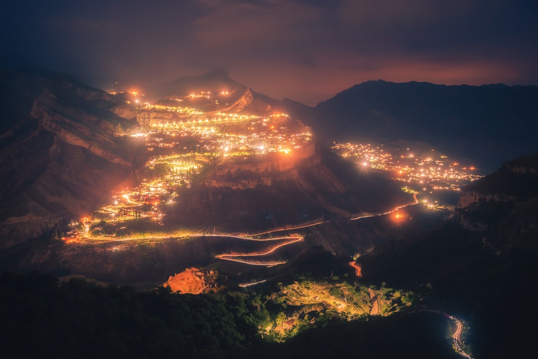 A night time view of a town and mountains