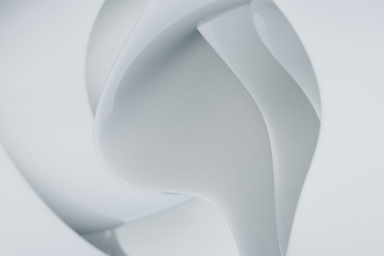 A close up of a white object with a white background