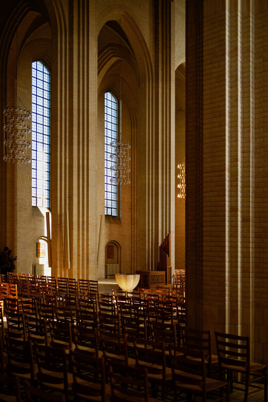 A church filled with lots of wooden chairs