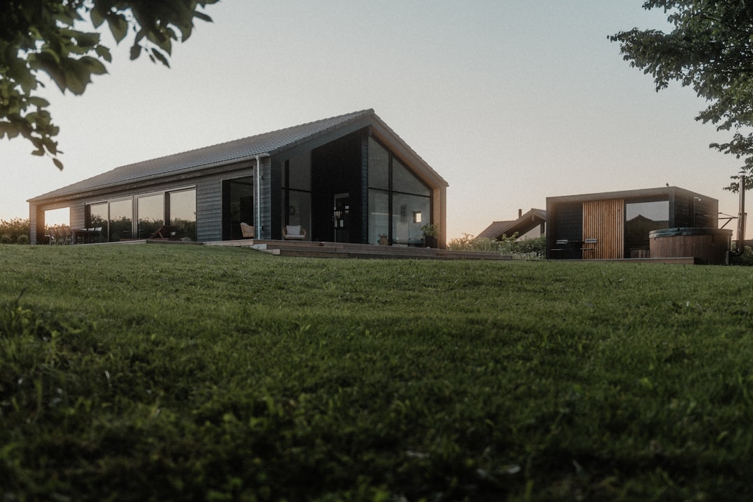 A grassy field with a building in the background