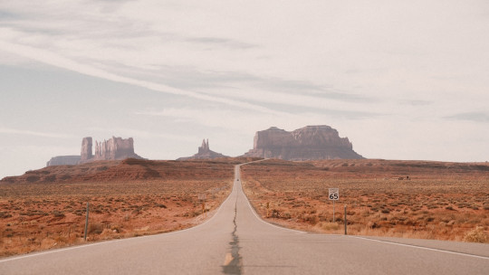 An empty road in the middle of a desert