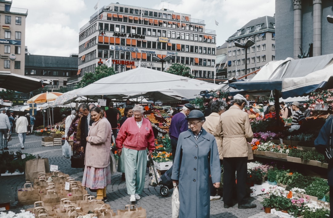 A group of people walking around a market