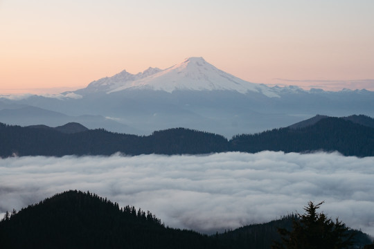 A view of a mountain covered in clouds