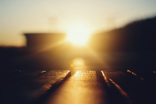 A blurry photo of the sun setting over a highway