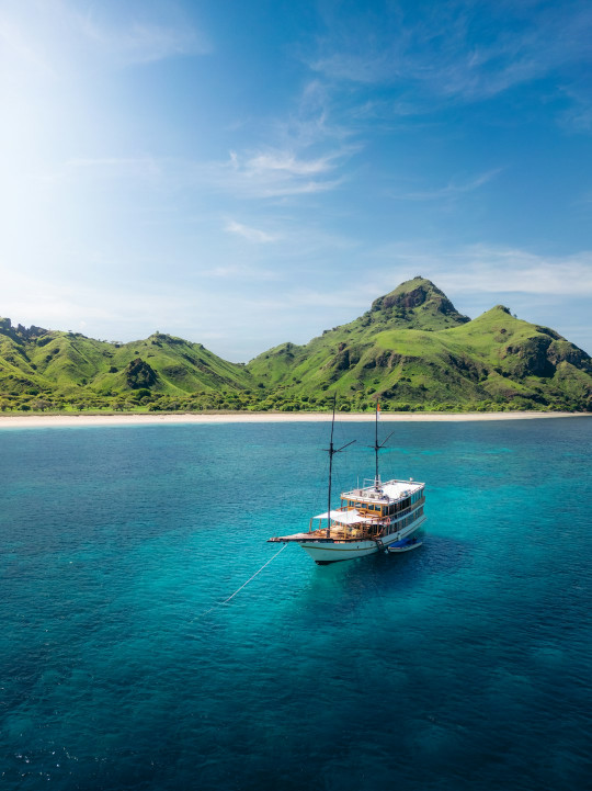 A boat floating on top of a large body of water