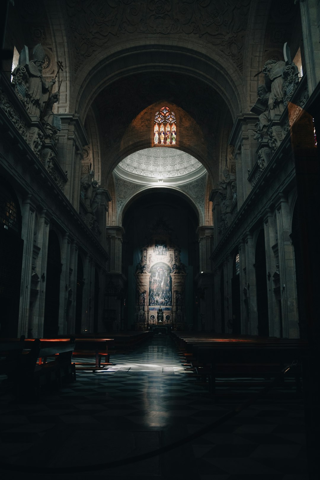 An empty church with pews and stained glass windows