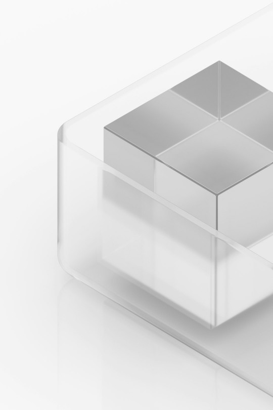 A glass box with a silver square in it