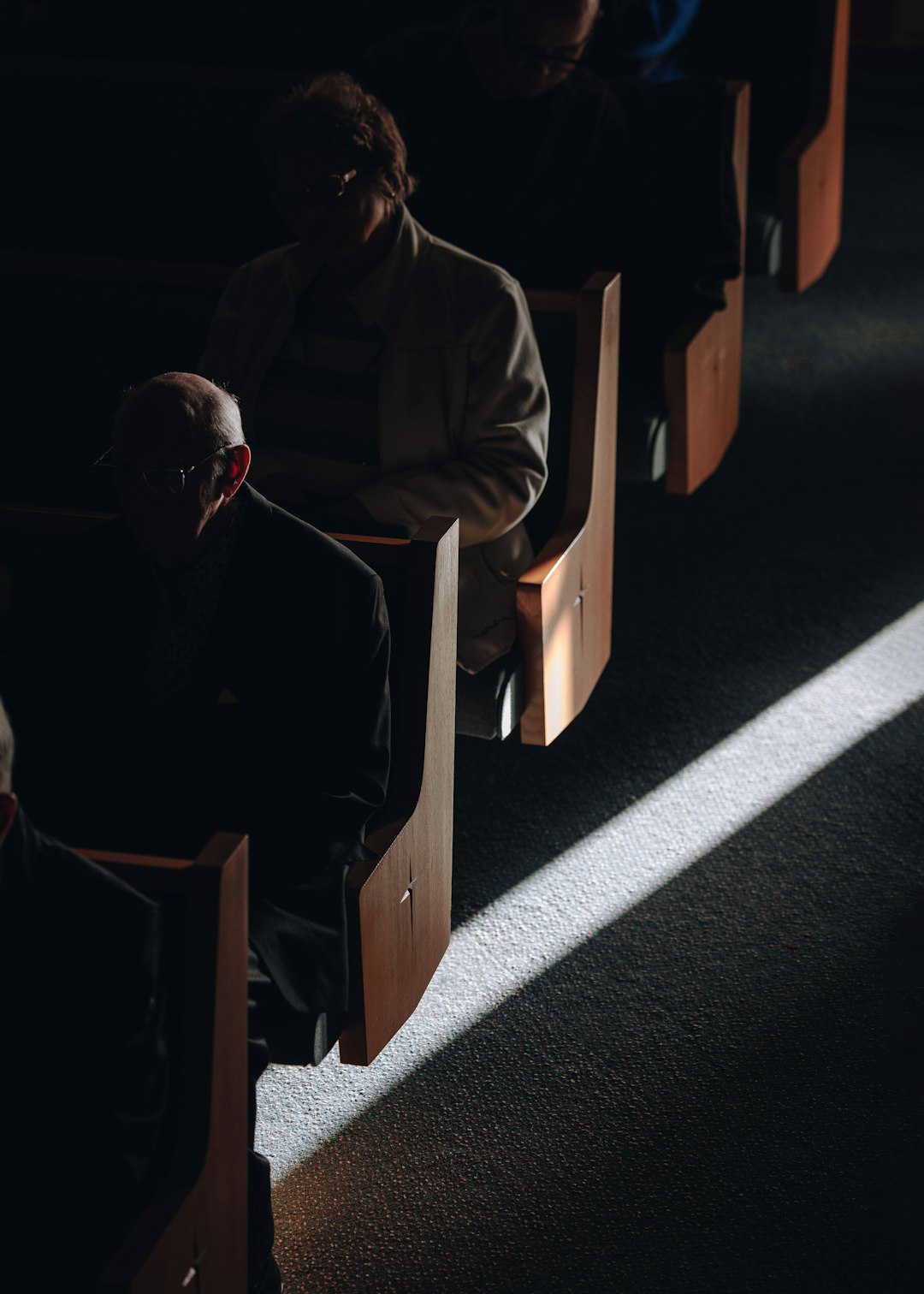 A group of people sitting in pews in a church