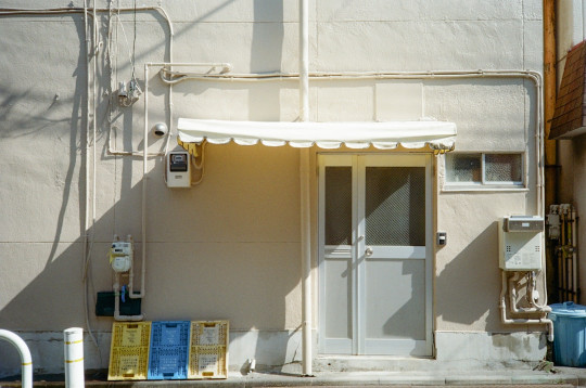 A building with a white awning next to a street