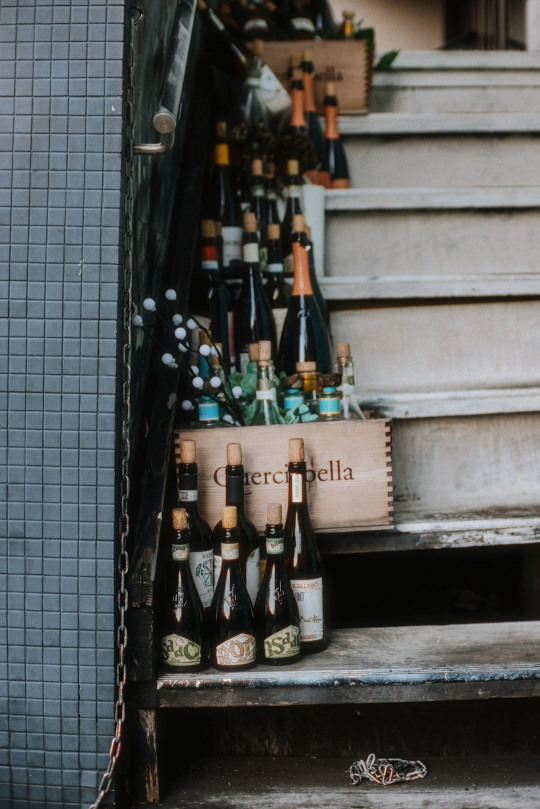 A bunch of bottles that are sitting on some steps