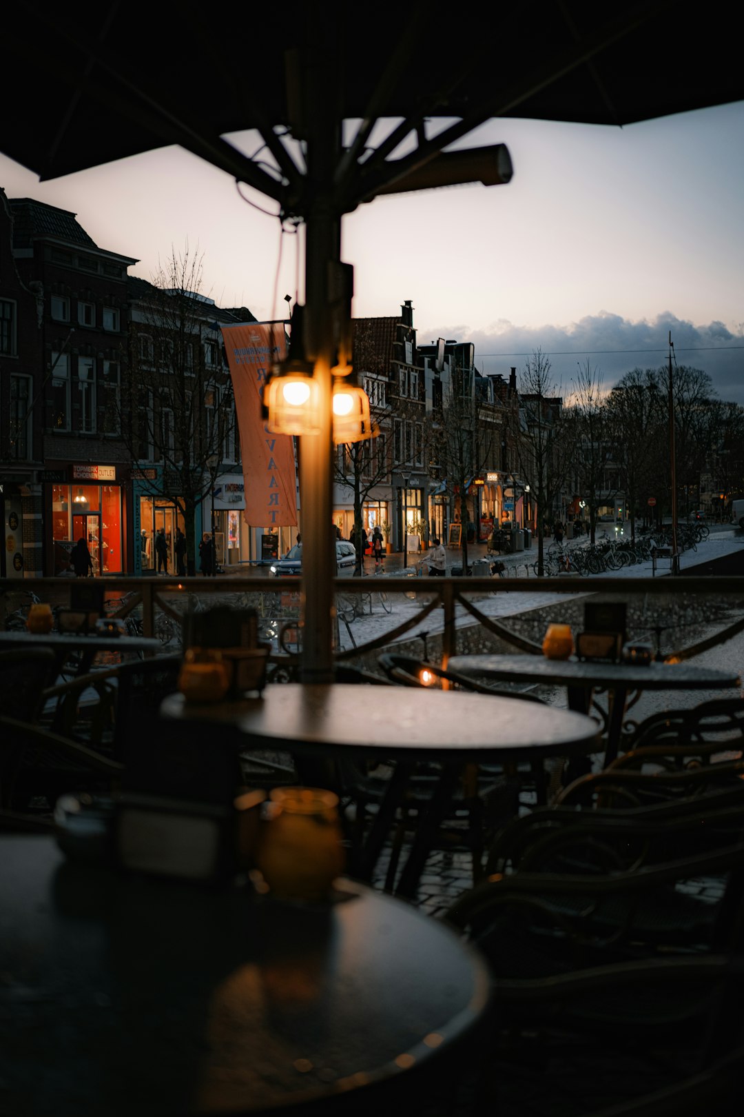 A view of a street at dusk from a restaurant