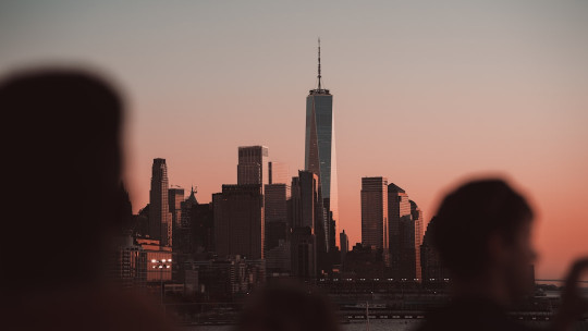 A group of people standing in front of a city skyline