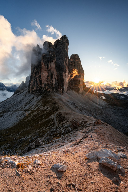 A mountain with a very tall tower on top of it