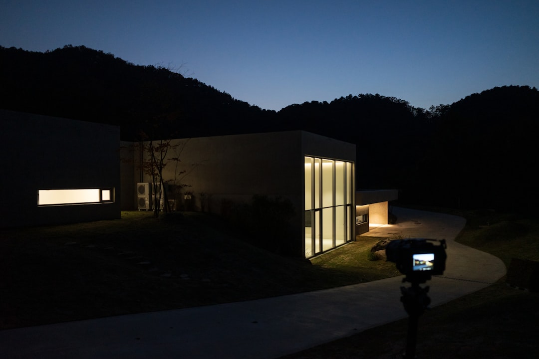 A night time view of a house with a parking meter in front of it