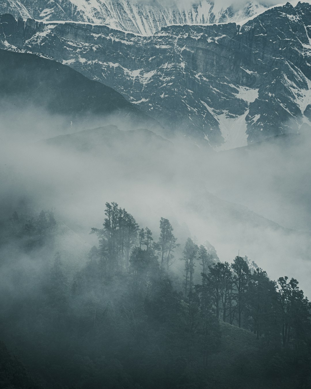 A mountain covered in fog and clouds