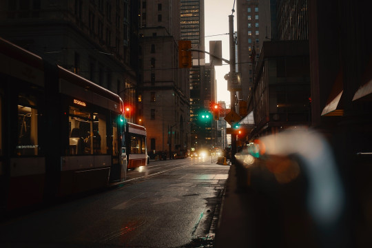 A city street filled with traffic and tall buildings