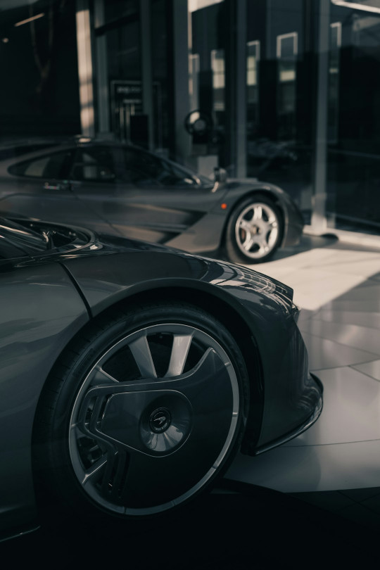 A couple of cars that are parked in a garage