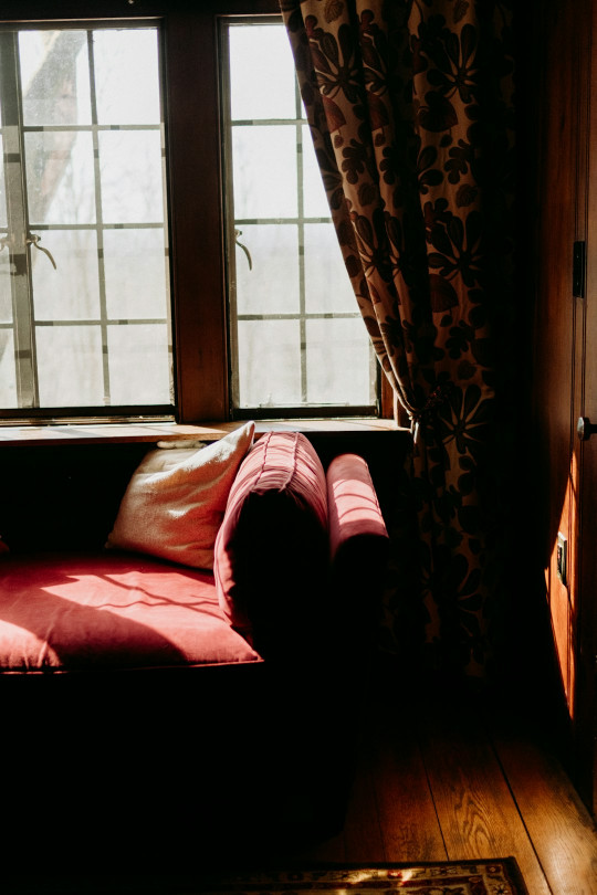 A couch sitting in front of a window in a living room