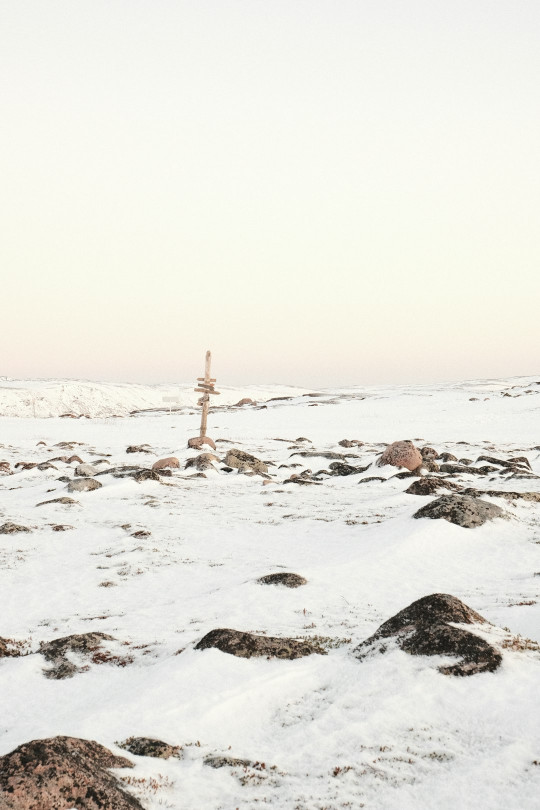 A man riding a snowboard down a snow covered slope