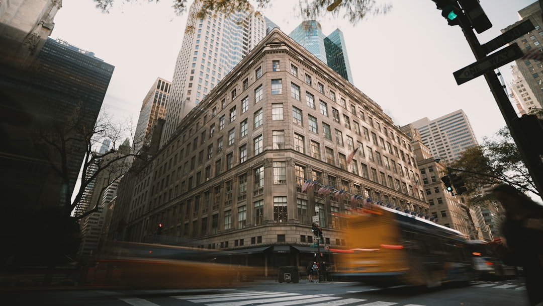 A city street filled with traffic next to tall buildings