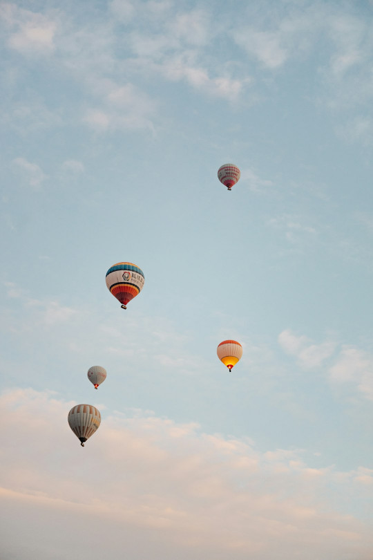 A group of hot air balloons flying in the sky