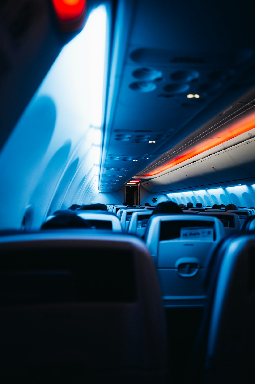 The inside of an airplane with the lights on