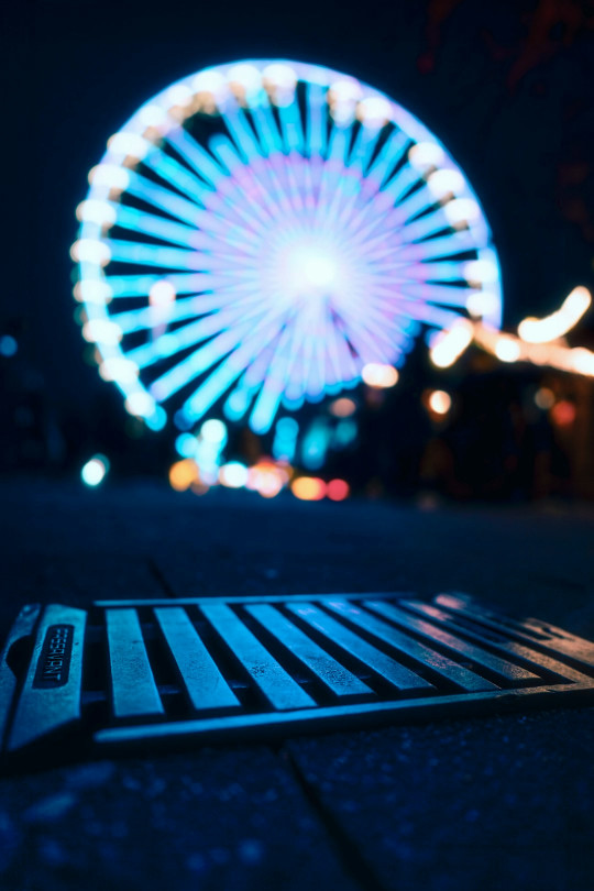 A lit up ferris wheel in the background