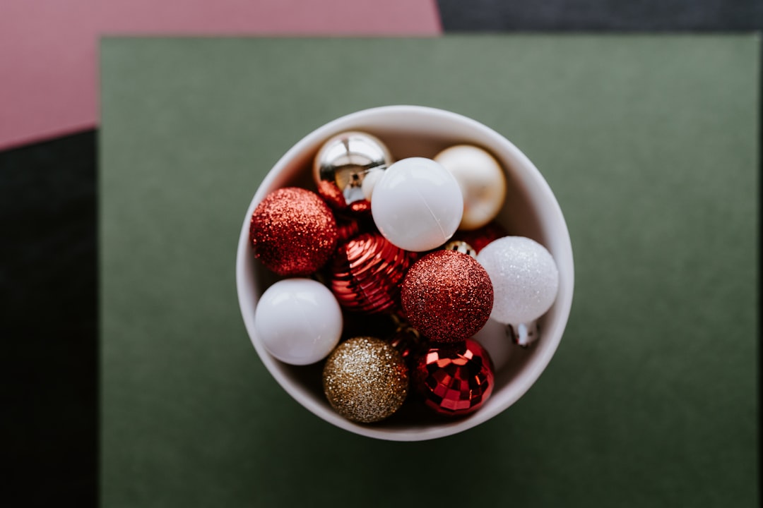 A cup filled with ornaments on top of a table