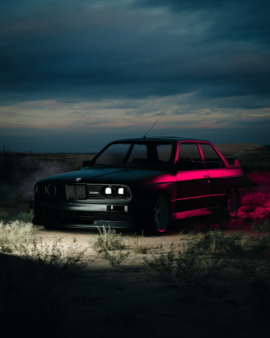 A car parked on a dirt road under a cloudy sky