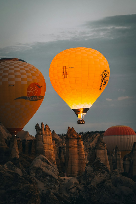 A group of hot air balloons flying in the sky