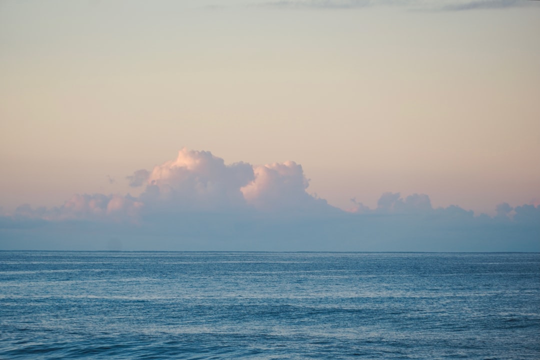 A large body of water under a cloudy sky