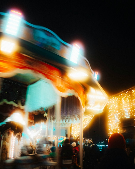 A blurry photo of a merry go round at night