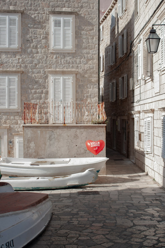 A couple of boats that are sitting in the street