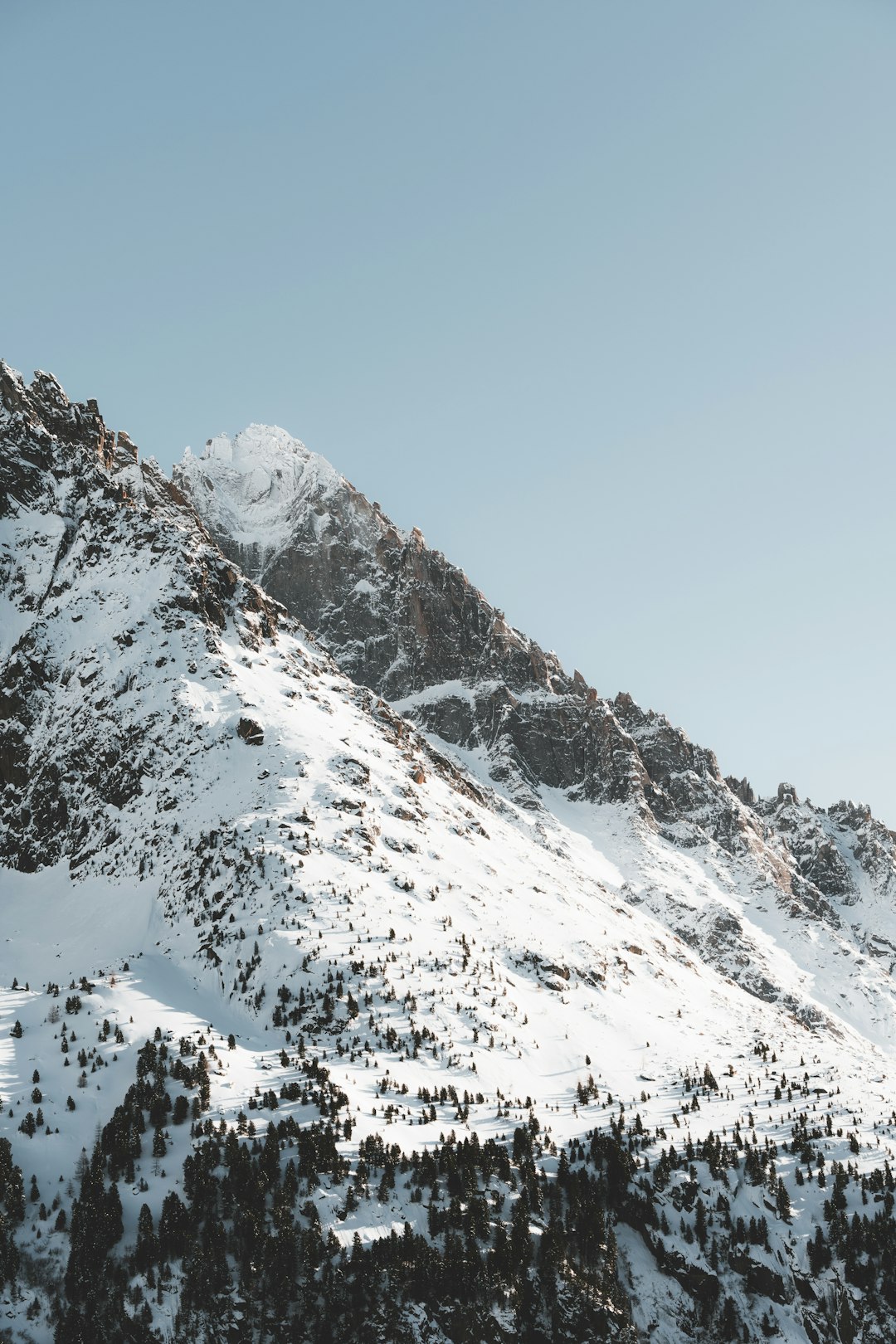 A snowboarder is doing a trick in the air