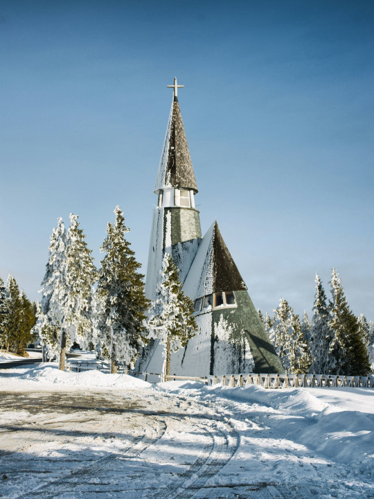 A church in the middle of a snowy field