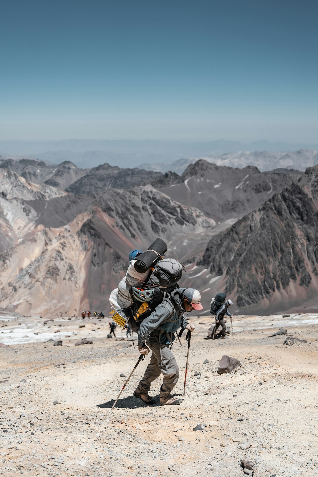 A man with a backpack climbing up a mountain