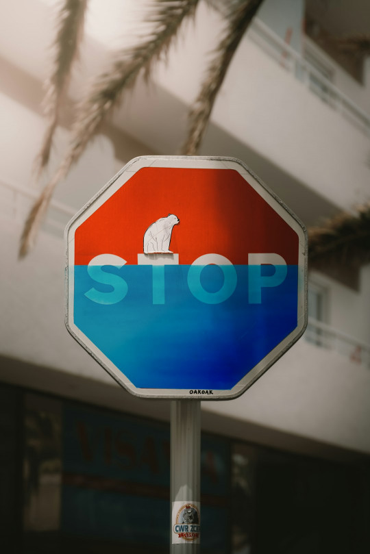 A stop sign with a polar bear on it