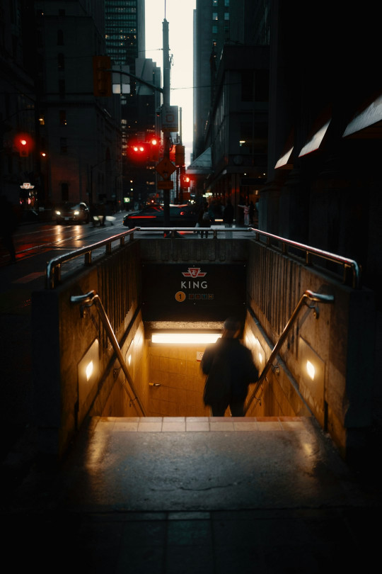 A person walking up a ramp in a city at night