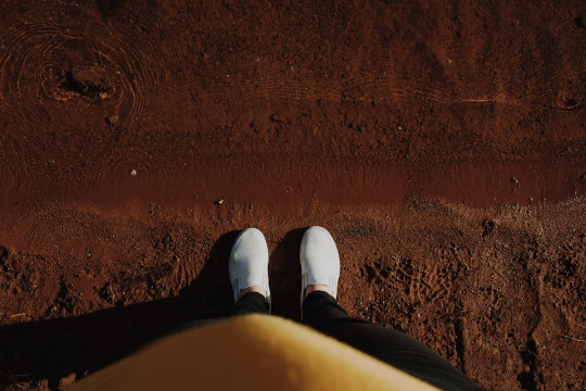 unknown person stepping on brown sand