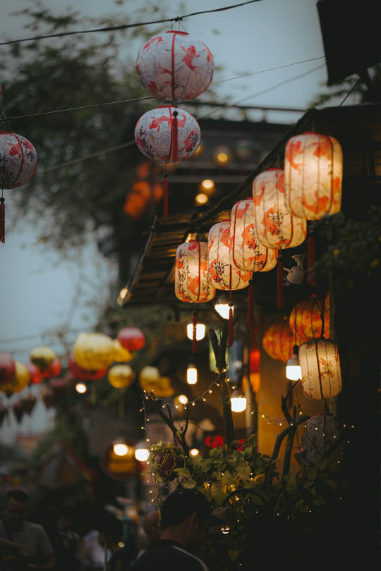 A group of red and white lanterns hanging from a building