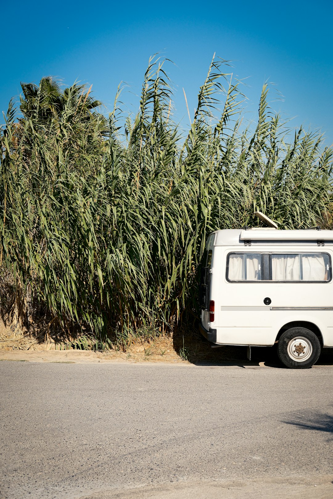 A white van parked on the side of a road