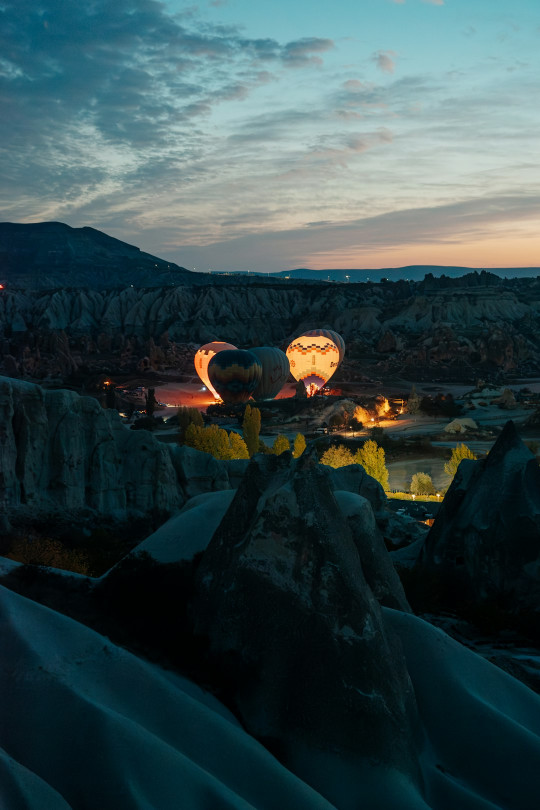 A couple of hot air balloons in the sky