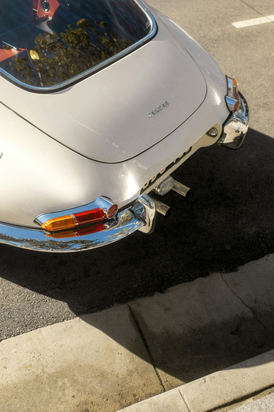 A white car parked on the side of the road